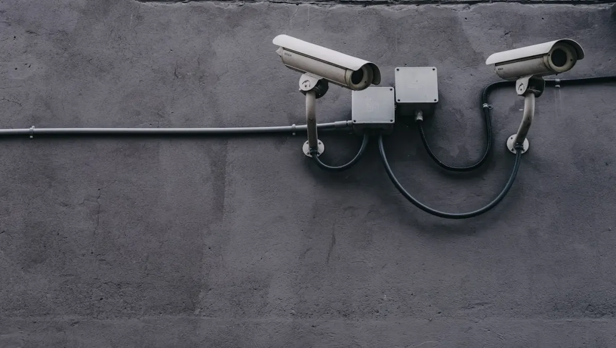 Two CCTV security cameras installed on the exterior wall of a property